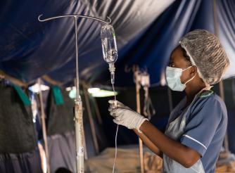 A nurse in Blantyre, Malawi attending to patients in a tent